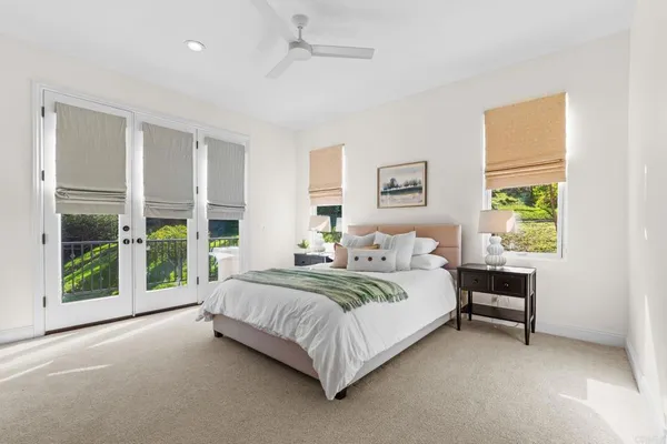 a large bed sitting in a bedroom next to a window