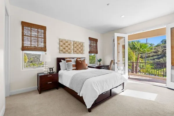 a bedroom with a bed and a large window
