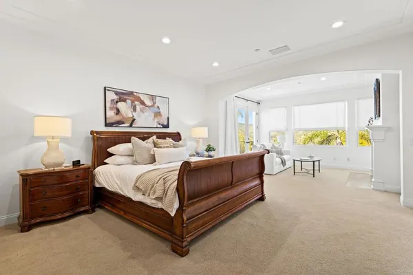 a bedroom with a bed and a painting on the wall