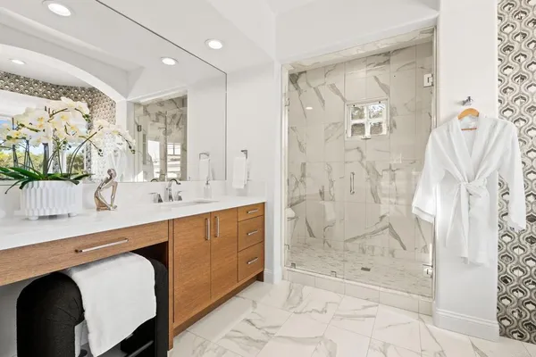 a spacious bathroom with a shower sink and mirror