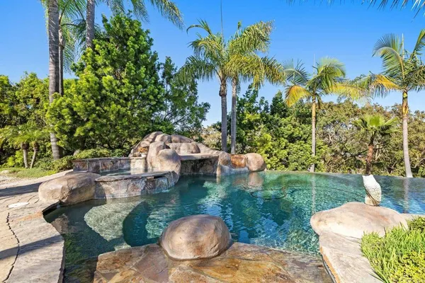 a view of a backyard with sitting area