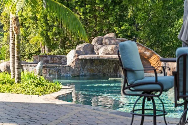 a wooden bench sitting in a yard next to a yard