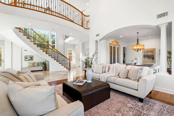 a living room with furniture and a chandelier