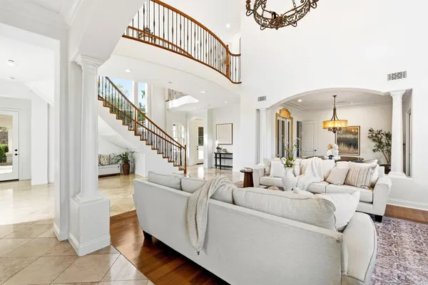 a living room with furniture and a chandelier