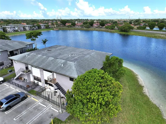 an aerial view of a houses with a lake view