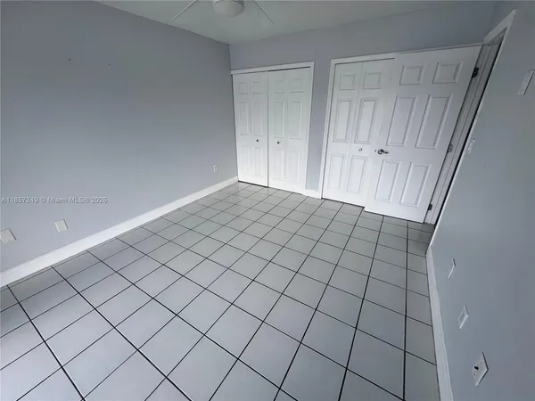 a view of an empty room and wooden floor