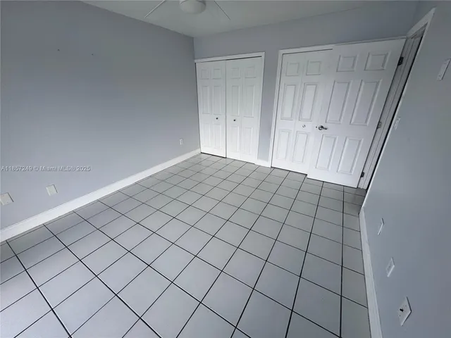 a view of an empty room and wooden floor