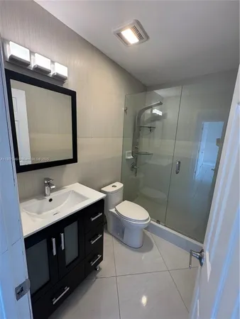 a bathroom with a sink toilet and mirror