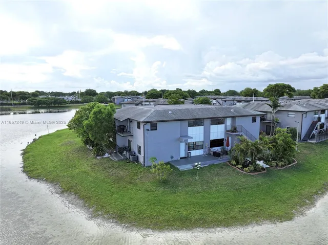 a view of a lake with houses in the back