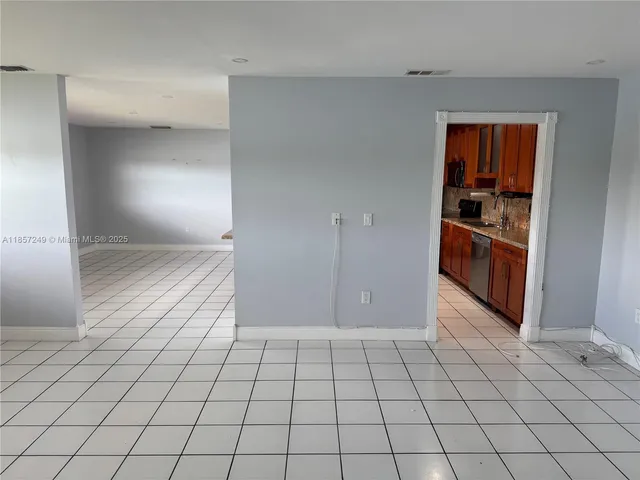 a view of a livingroom with an empty space and a window