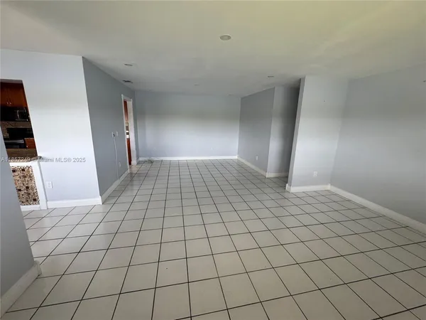 a view of an empty room and wooden floor