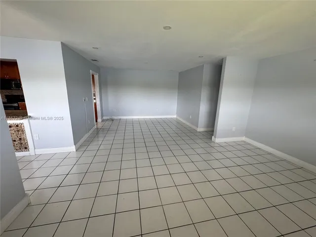 a view of an empty room and wooden floor