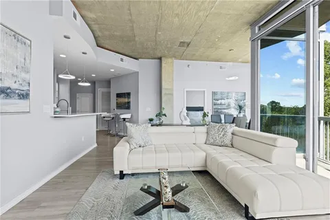 a living room with furniture and a large window