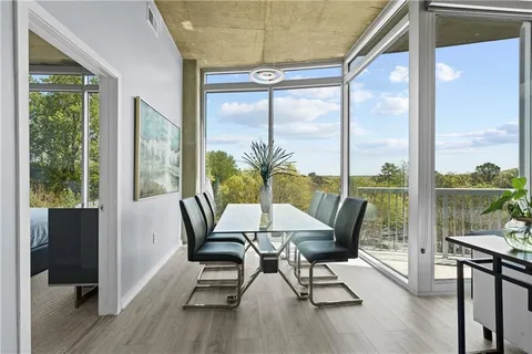 a view of a dining room with furniture window and wooden floor
