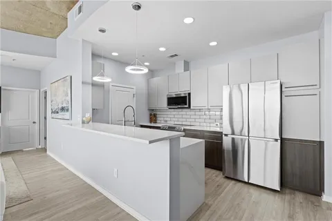 a kitchen with sink attached with living room
