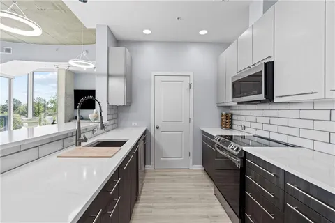 a kitchen with stainless steel appliances and refrigerator