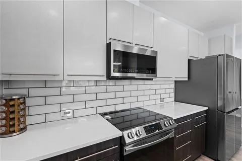 a kitchen with stainless steel appliances granite countertop a stove and a refrigerator
