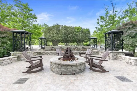 a view of a swimming pool with outdoor seating and a patio