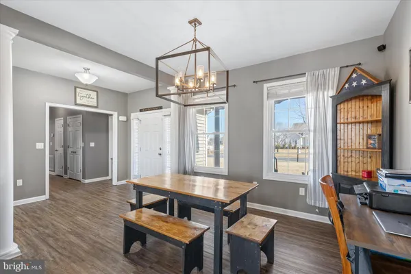 a living room with furniture a window and wooden floor