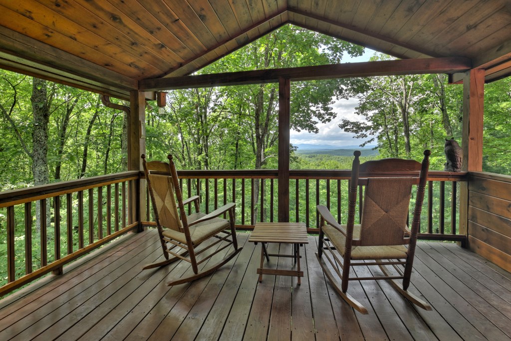 548 Mountain Highlands Court Blue Ridge, GA 30513 - Photo 18 of 33 a view of a two chairs in the deck next to a yard