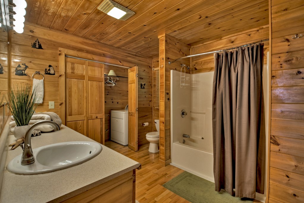548 Mountain Highlands Court Blue Ridge, GA 30513 - Photo 23 of 33 a bathroom with a sink and a mirror