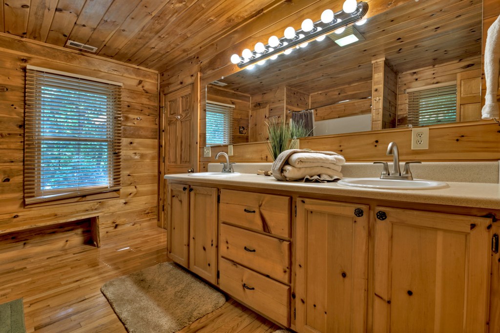 548 Mountain Highlands Court Blue Ridge, GA 30513 - Photo 24 of 33 a bathroom with a sink and a mirror