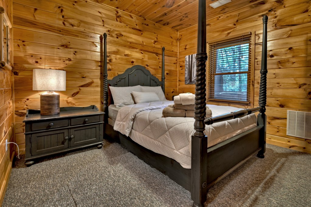 548 Mountain Highlands Court Blue Ridge, GA 30513 - Photo 29 of 33 a bed room with a bed and a window