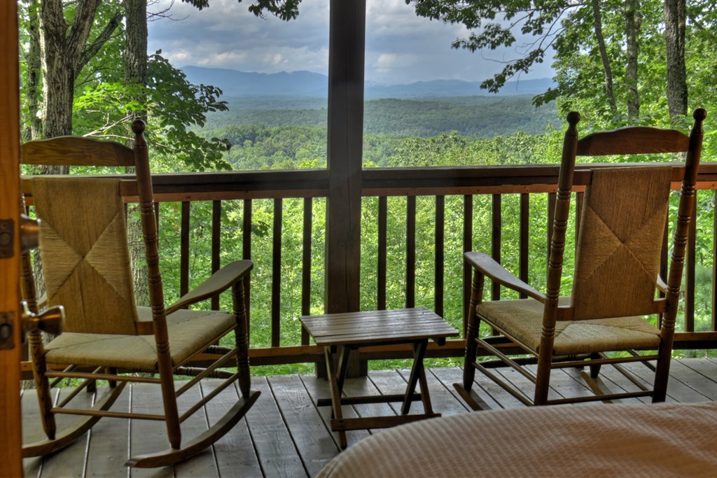 548 Mountain Highlands Court Blue Ridge, GA 30513 - Photo 3 of 33 a view of a chairs and table in the balcony