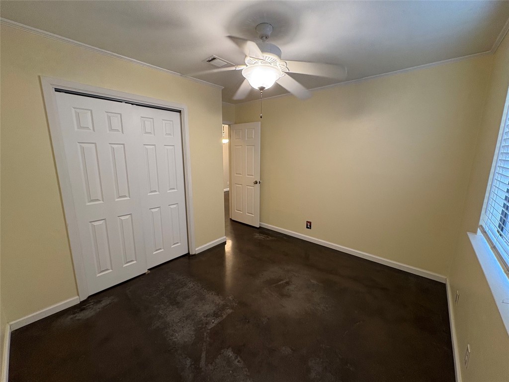 8713 Clearbrook Trail, Unit A Austin, TX 78729 - Photo 13 of 22 an empty room with a ceiling fan and closet area