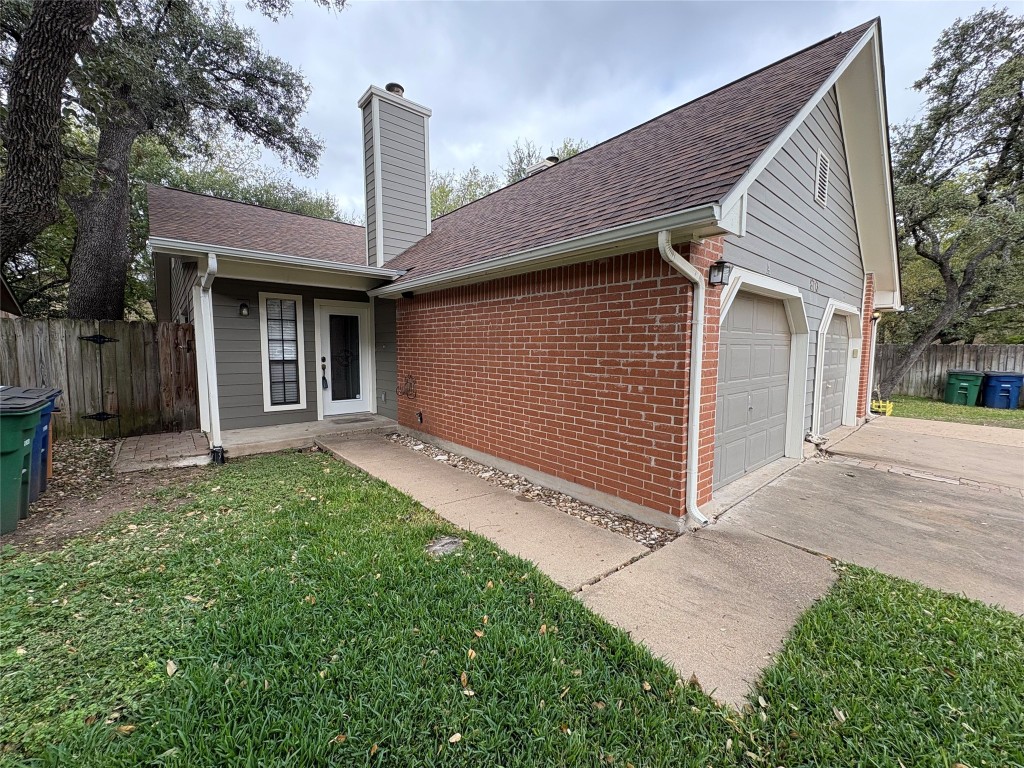 8713 Clearbrook Trail, Unit A Austin, TX 78729 - Photo 2 of 22 a front view of a house with garage