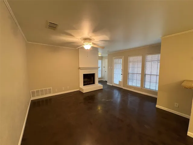 a view of wooden floor and windows in a room