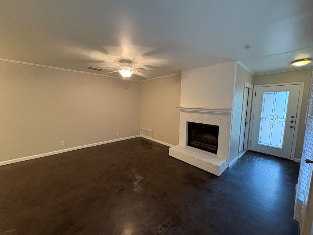 8713 Clearbrook Trail, Unit A Austin, TX 78729 - Photo 4 of 22 an empty room with a fireplace and wooden floor