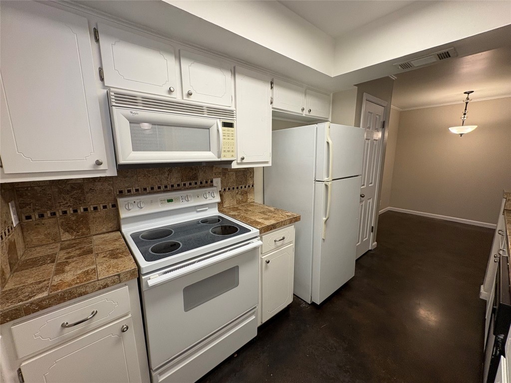 8713 Clearbrook Trail, Unit A Austin, TX 78729 - Photo 10 of 22 a kitchen with cabinets and white stainless steel appliances