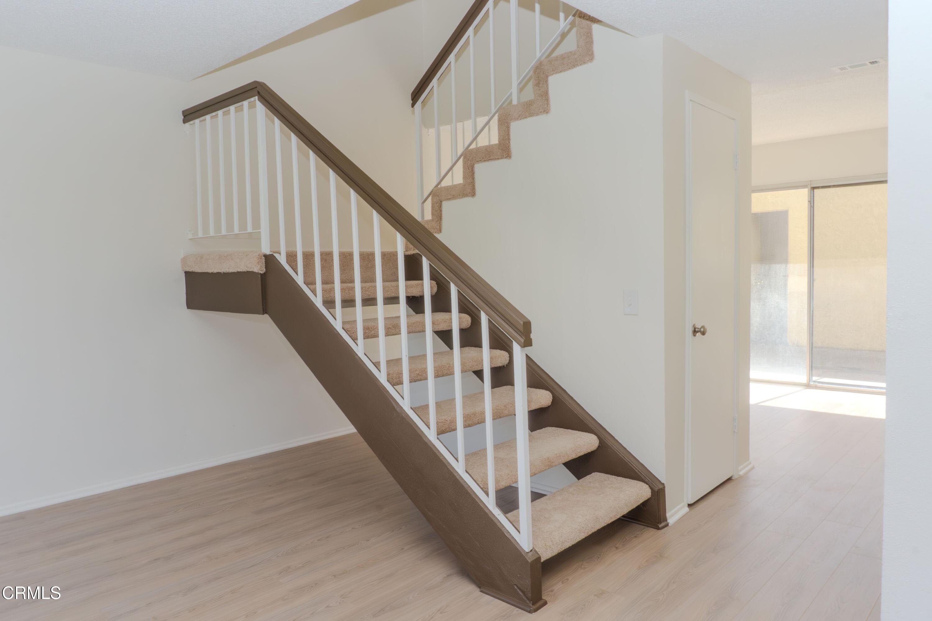 5313 Perkins Road Oxnard, CA 93033 - Photo 14 of 40 a view of staircase with railing and white walls