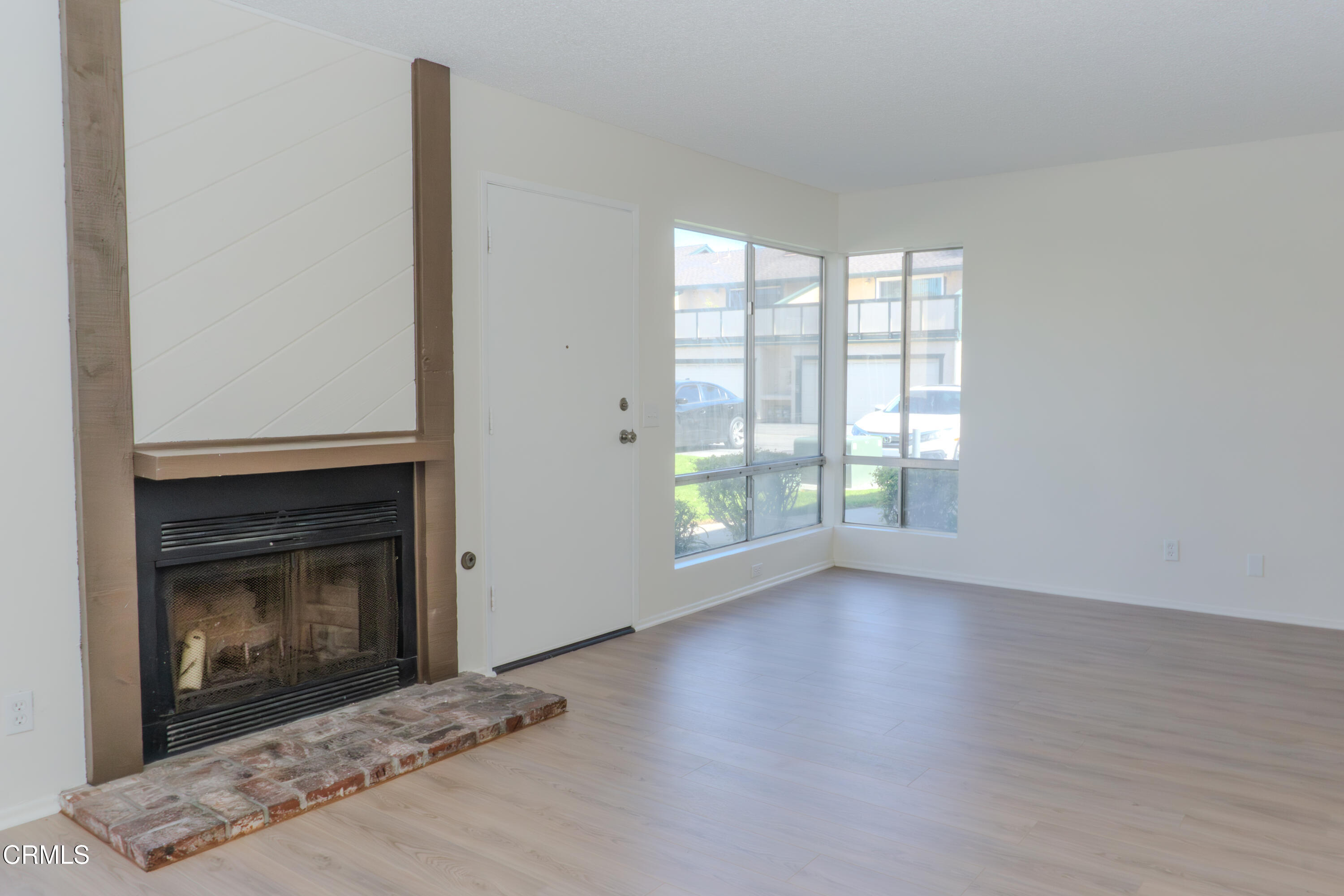 5313 Perkins Road Oxnard, CA 93033 - Photo 5 of 40 a view of empty room with wooden floor and fireplace