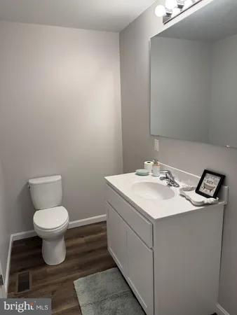 a bathroom with a sink toilet and a mirror