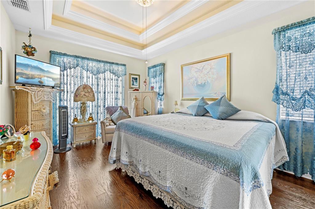 1245 Coble Road Spring Hill, FL 34608 - Photo 12 of 50 a bedroom with a bed and wooden floor