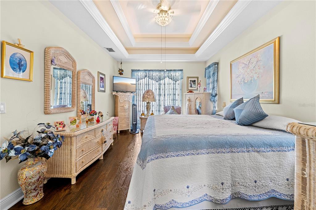 1245 Coble Road Spring Hill, FL 34608 - Photo 13 of 50 a bed room with a bed and a chandelier