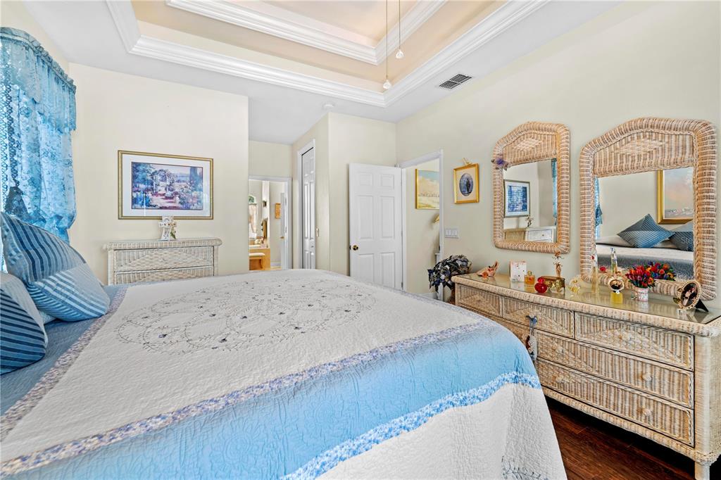 1245 Coble Road Spring Hill, FL 34608 - Photo 14 of 50 a bedroom with a bed a dresser and baby crib