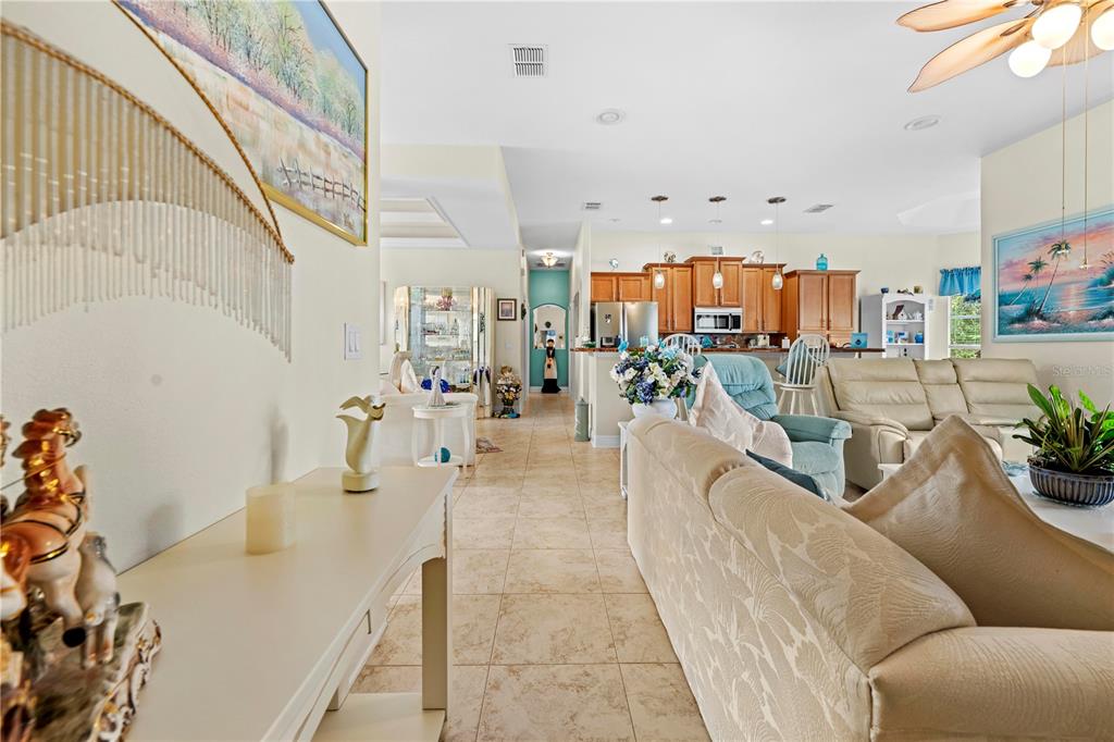 1245 Coble Road Spring Hill, FL 34608 - Photo 21 of 50 a living room with furniture and a chandelier