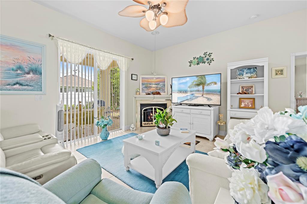 1245 Coble Road Spring Hill, FL 34608 - Photo 28 of 50 a living room with furniture chandelier and a fireplace