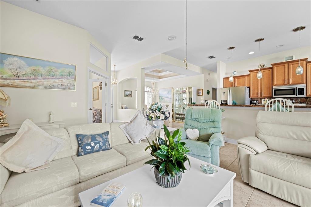 1245 Coble Road Spring Hill, FL 34608 - Photo 30 of 50 a living room with furniture kitchen and a chandelier