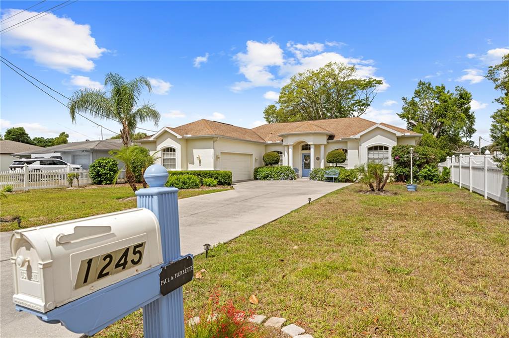 1245 Coble Road Spring Hill, FL 34608 - Photo 3 of 50 a view of a house with a yard and potted plants