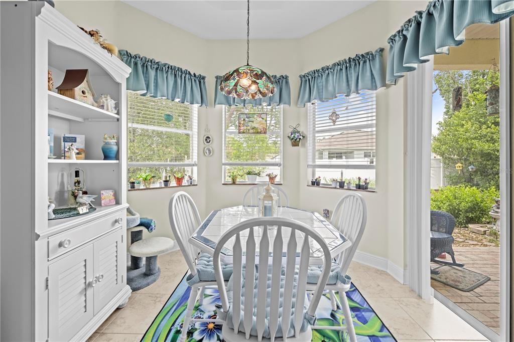 1245 Coble Road Spring Hill, FL 34608 - Photo 33 of 50 a view of a dining room with furniture window and wooden floor