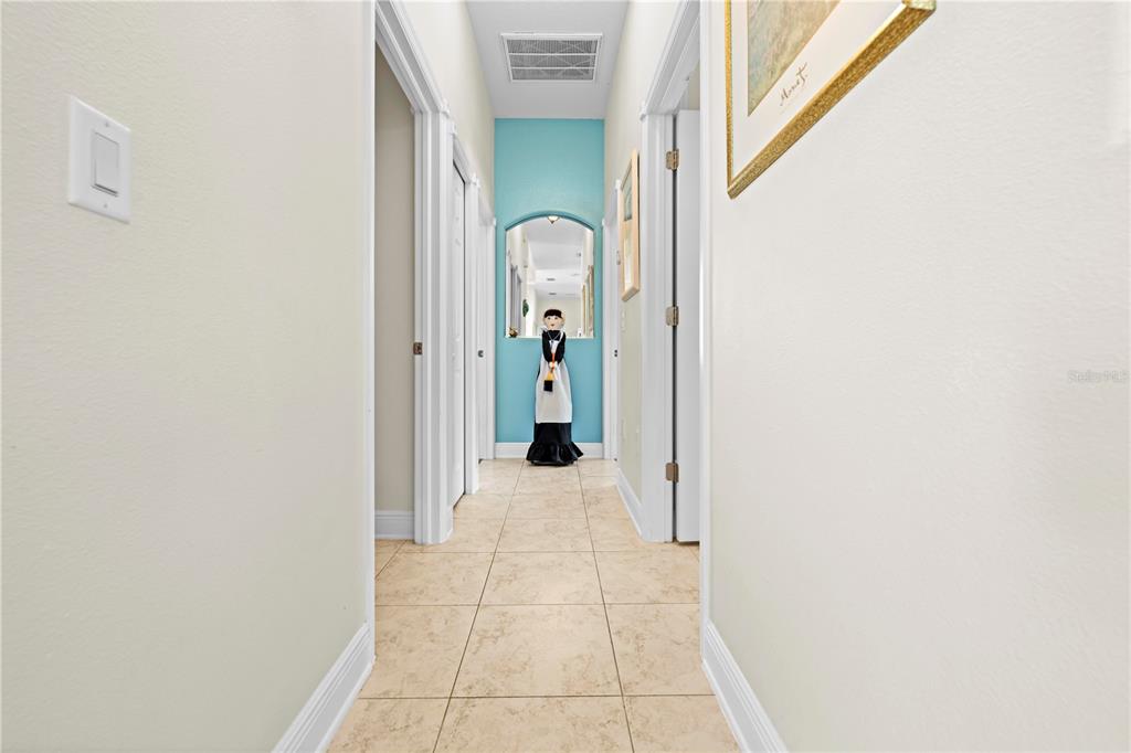 1245 Coble Road Spring Hill, FL 34608 - Photo 39 of 50 a view of a hallway with wooden shelves