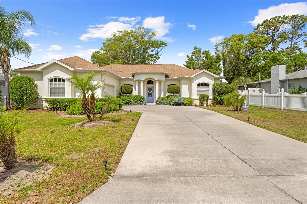 1245 Coble Road Spring Hill, FL 34608 - Photo 4 of 50 a front view of a house with a yard