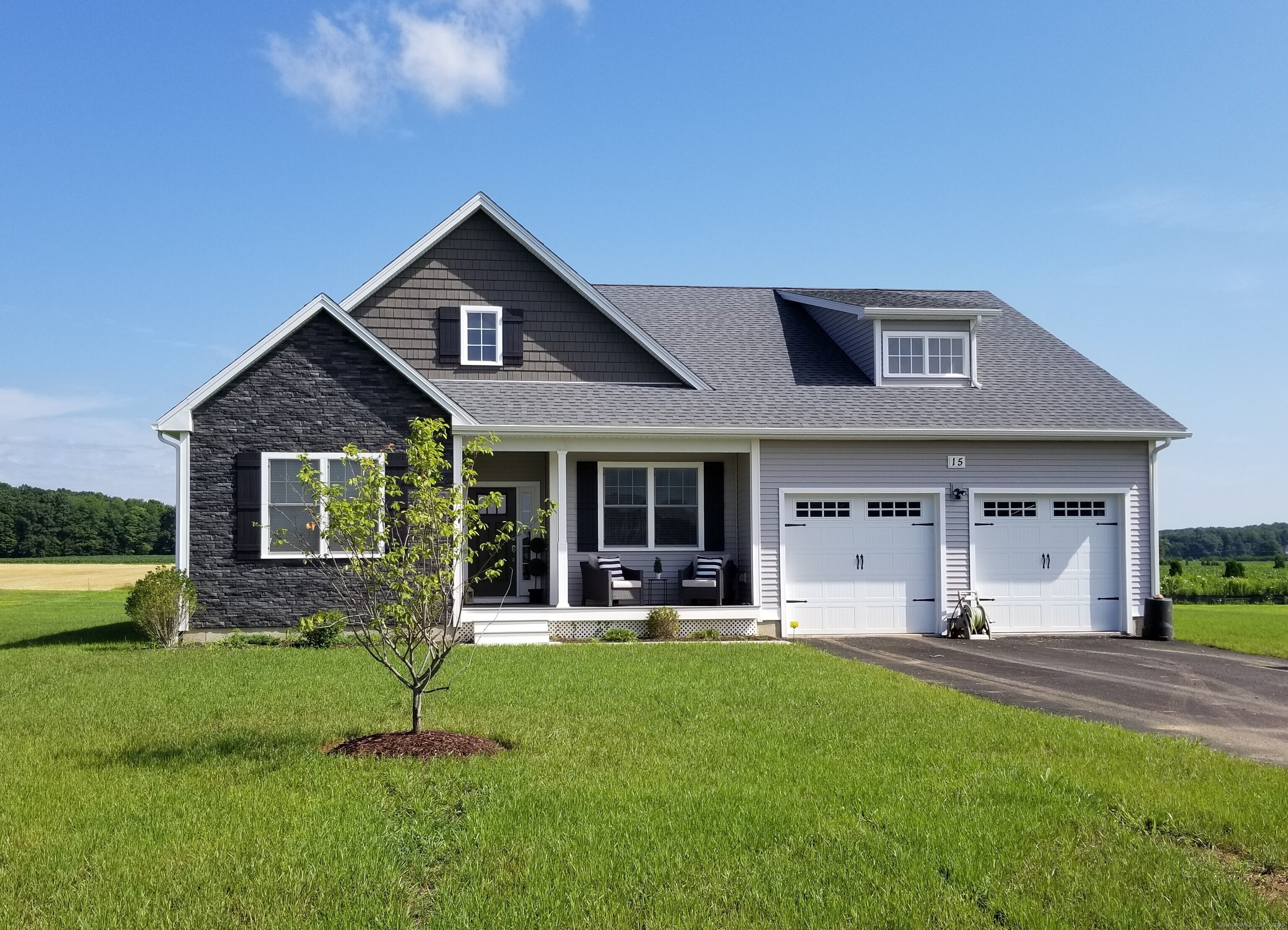 318 Capen Street Windsor, CT 06095 - Photo 1 of 37 a front view of a house with a yard and garage
