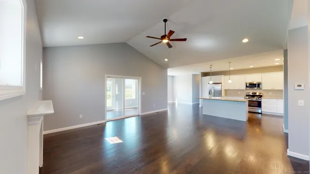 a view of a living room a kitchen and a wooden floor