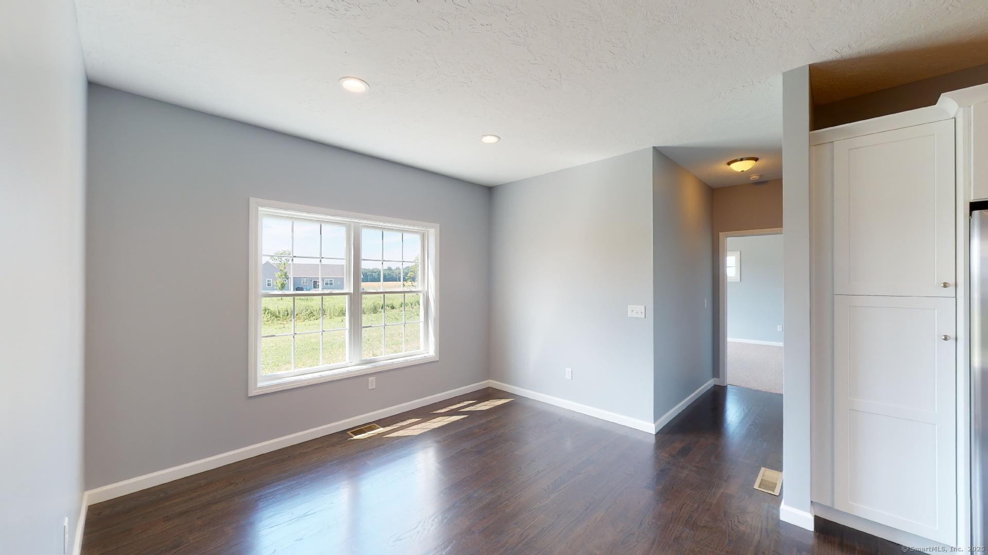 318 Capen Street Windsor, CT 06095 - Photo 13 of 37 an empty room with wooden floor and windows