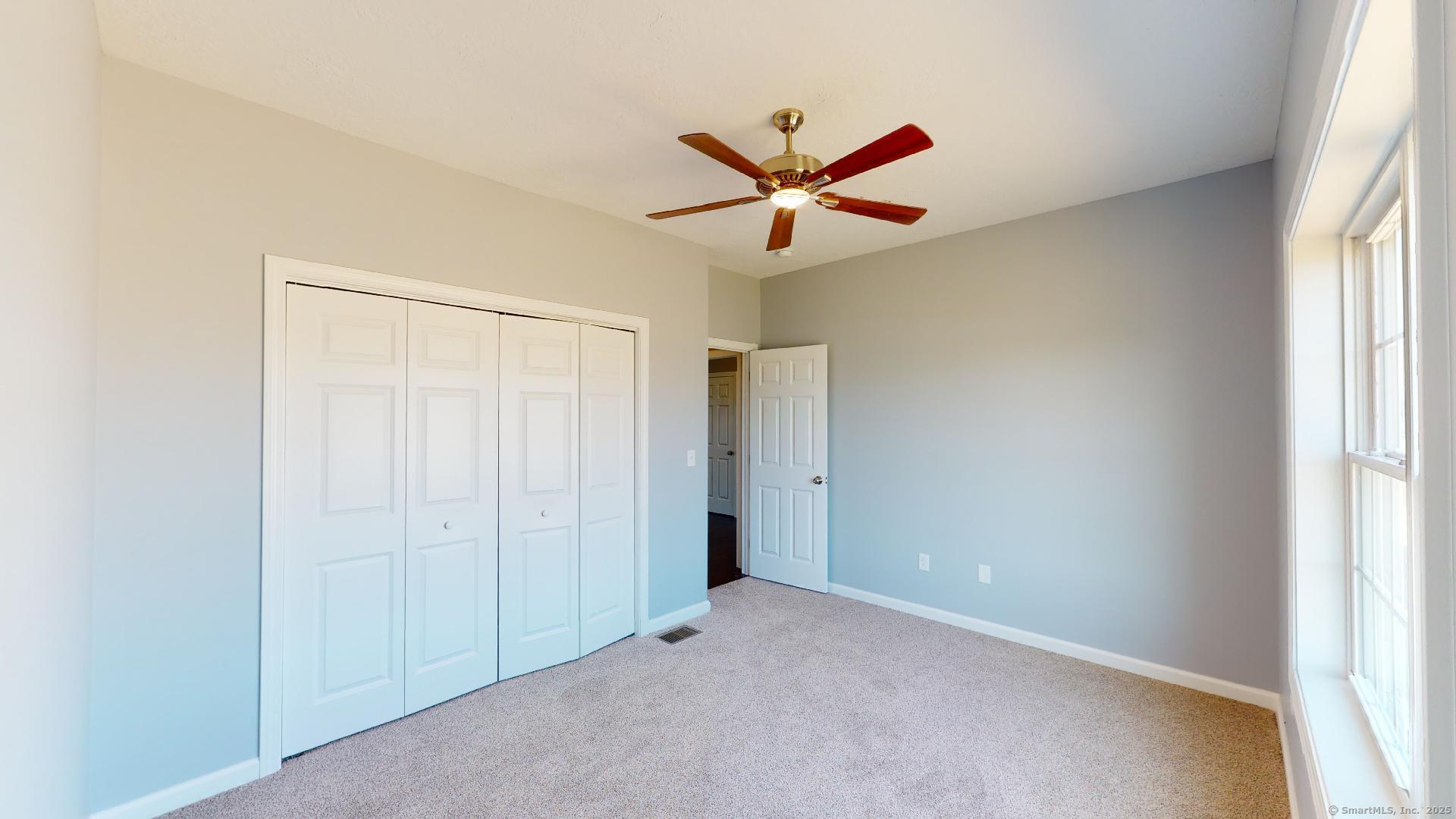 318 Capen Street Windsor, CT 06095 - Photo 27 of 37 a view of a livingroom with a ceiling fan and window
